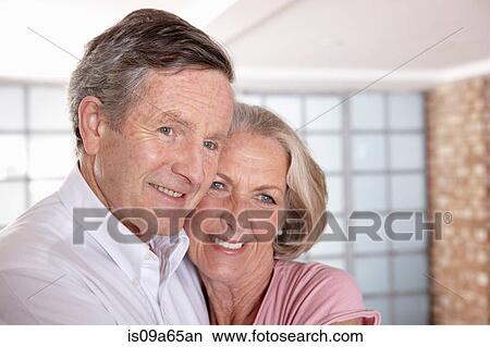 Older couple hugging in living room View Large Photo Image Picture - Older couple hugging in living room. Fotosearch
