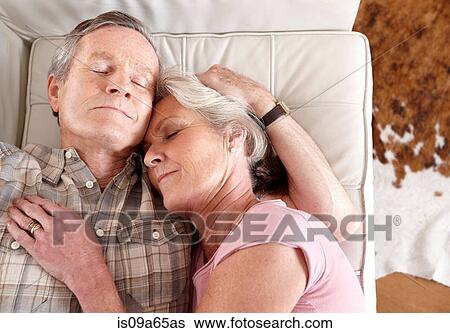 Older couple napping on sofa View Large Photo Image Stock Photograph - Older couple napping on sofa. Fotosearch