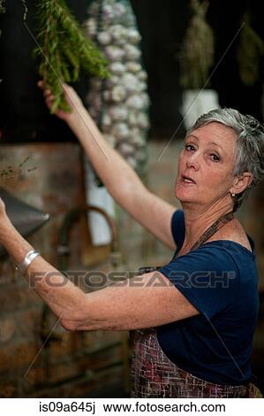 Older woman holding tree leaves View Large Photo Image Stock Image - Older woman holding tree leaves. Fotosearch