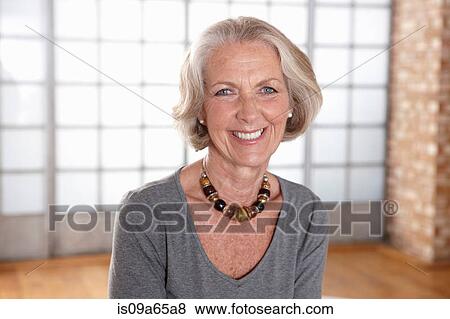 Older woman smiling indoors View Large Photo Image Stock Photo - Older woman smiling indoors. Fotosearch