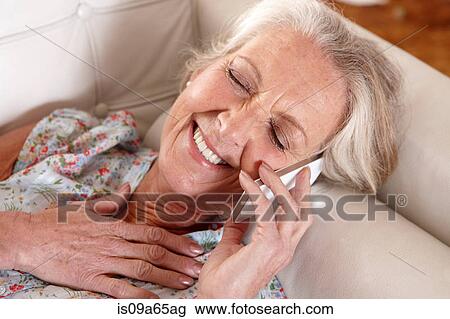 Older woman talking on cell phone View Large Photo Image Stock Image - Older woman talking on cell phone. Fotosearch