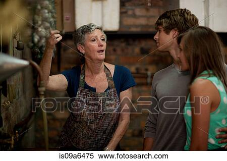 Stock Photography - Older woman talking to couple. Fotosearch