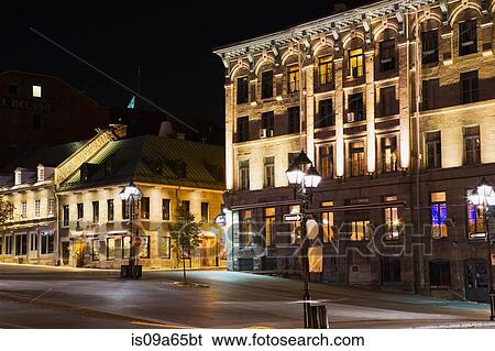 Stock Photograph - Ornate city buildings lit up at night. Fotosearch