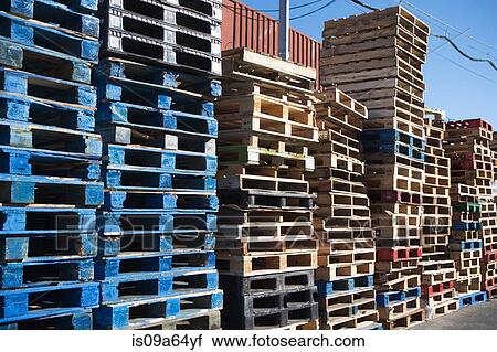 Stock Image - Pallets stacked together in yard. Fotosearch