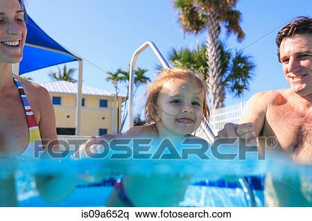 Parents swimming with toddler in pool View Large Photo Image Stock Photography - Parents swimming with toddler in pool. Fotosearch