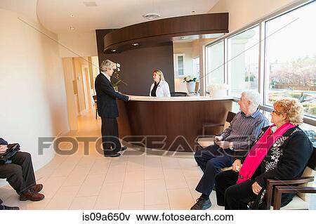 Stock Photo - Patients in doctor's waiting room. Fotosearch