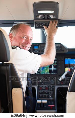 Pilot smiling in airplane cockpit View Large Photo Image Stock Image - Pilot smiling in airplane cockpit. Fotosearch