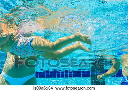 Picture - Pregnant mother and toddler in pool. Fotosearch