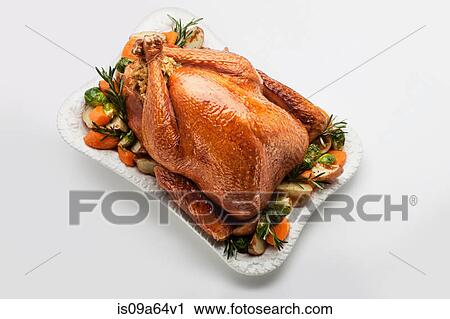 Stock Image - Roast stuffed chicken with vegetables. Fotosearch