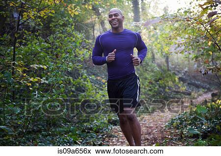 Stock Photo - Runner on forest trail. Fotosearch