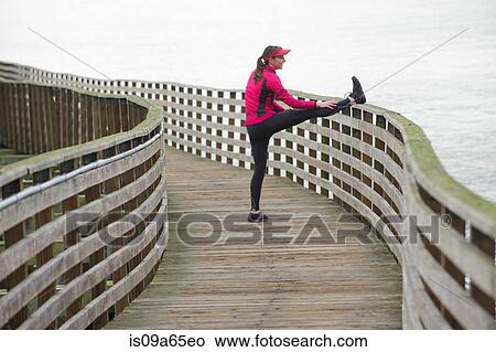Runner stretching on wooden dock View Large Photo Image Picture - Runner stretching on wooden dock. Fotosearch
