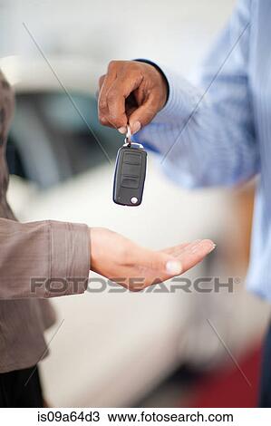 Salesman handing woman new car keys View Large Photo Image Stock Image - Salesman handing woman new car keys. Fotosearch