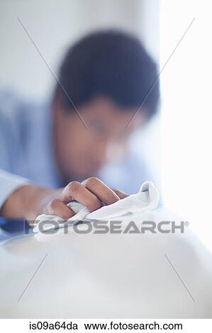 Salesman shining up new car View Large Photo Image Stock Image - Salesman shining up new car. Fotosearch