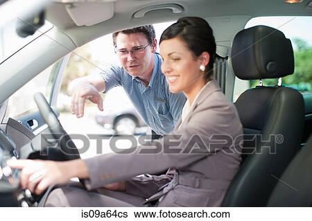 Salesman showing woman new car View Large Photo Image Stock Photograph - Salesman showing woman new car. Fotosearch