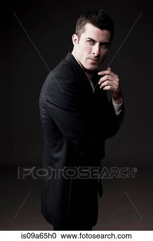 Serious man looking over his shoulder View Large Photo Image Stock Image - Serious man looking over his shoulder. Fotosearch