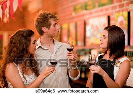 Stock Photograph - Server and customers tasting wine. Fotosearch
