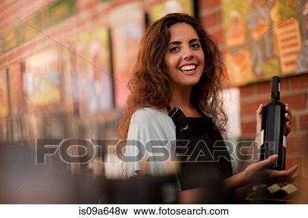 Stock Photo - Server holding glass of wine in grocery. Fotosearch