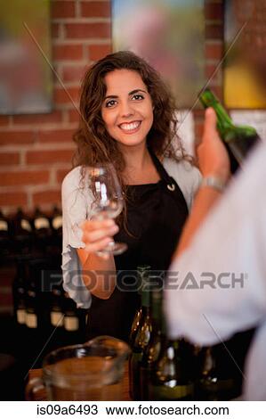 Server offering glass for wine tasting View Large Photo Image Stock Image - Server offering glass for wine tasting. Fotosearch