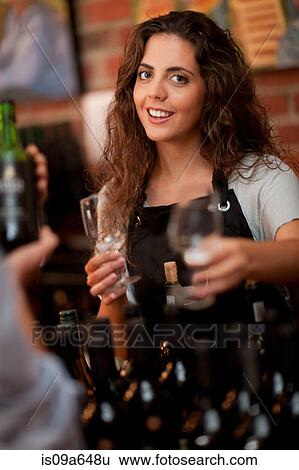 Stock Photograph - Server offering glass for wine tasting. Fotosearch