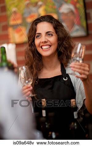 Stock Photo - Server taking glass for wine tasting. Fotosearch