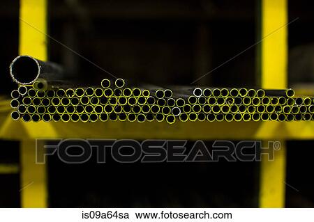 Stock Image - Shelves of colorful metal pipes in plant. Fotosearch
