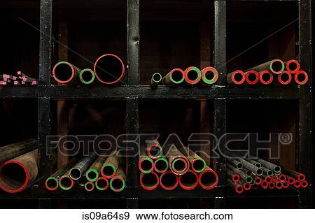 Shelves of colorful metal pipes in plant View Large Photo Image Stock Photo - Shelves of colorful metal pipes in plant. Fotosearch