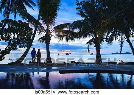 Stock Photo - Silhouette of couple on tropical beach. Fotosearch