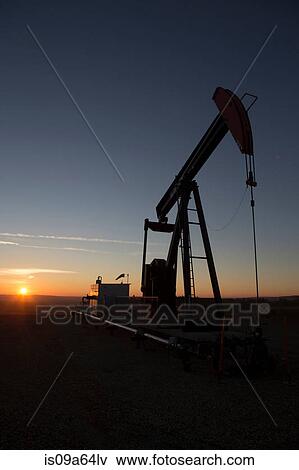 Silhouette of oil well in dry landscape View Large Photo Image Stock Photo - Silhouette of oil well in dry landscape. Fotosearch