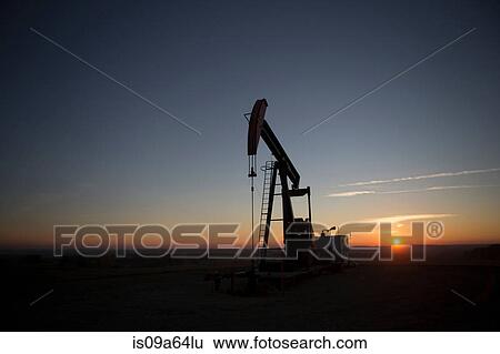 Silhouette of oil well in dry landscape View Large Photo Image Stock Photograph - Silhouette of oil well in dry landscape. Fotosearch