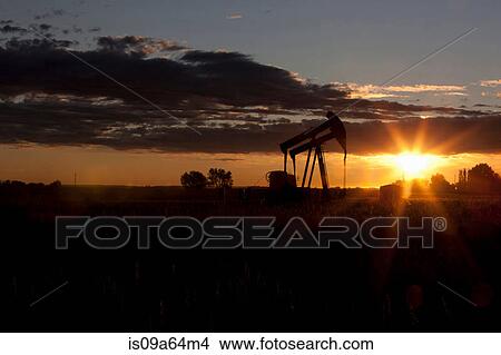 Silhouette of oil wells at sunset View Large Photo Image Picture - Silhouette of oil wells at sunset. Fotosearch