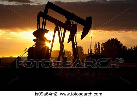 Silhouette of oil wells at sunset View Large Photo Image Stock Image - Silhouette of oil wells at sunset. Fotosearch