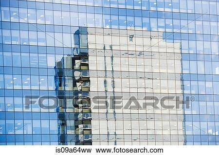 Stock Photo - Skyscraper reflected in windows. Fotosearch