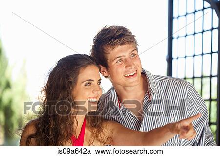 Stock Image - Smiling couple admiring view. Fotosearch