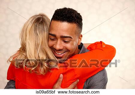 Stock Image - Smiling couple hugging. Fotosearch