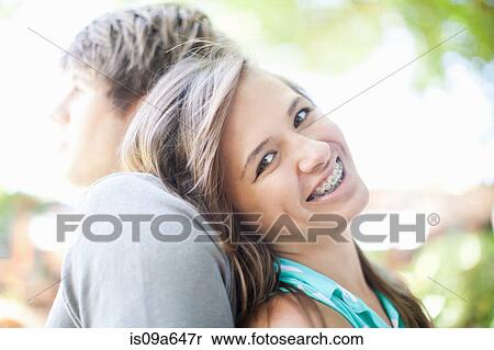 Smiling girl leaning on boyfriend View Large Photo Image Stock Photography - Smiling girl leaning on boyfriend. Fotosearch