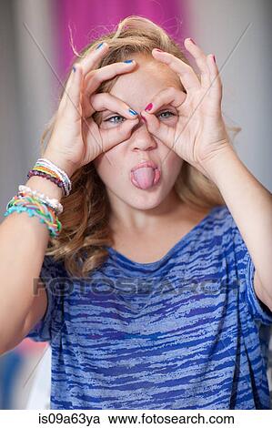 Stock Image - Smiling girl making face. Fotosearch