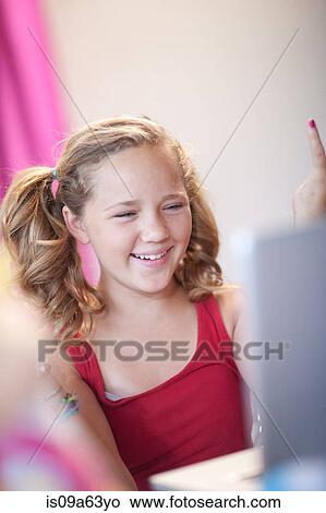 Smiling girl using laptop View Large Photo Image Picture - Smiling girl using laptop. Fotosearch