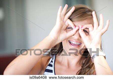 Stock Photo - Smiling teenage girl making face. Fotosearch
