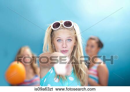 Smiling teenage girl pointing View Large Photo Image Stock Photograph - Smiling teenage girl pointing. Fotosearch