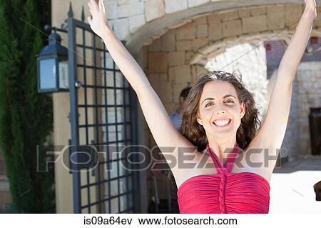 Stock Photo - Smiling woman cheering outdoors. Fotosearch