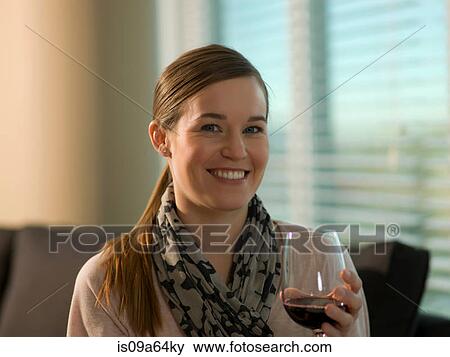 Smiling woman having glass of wine View Large Photo Image Stock Photo - Smiling woman having glass of wine. Fotosearch