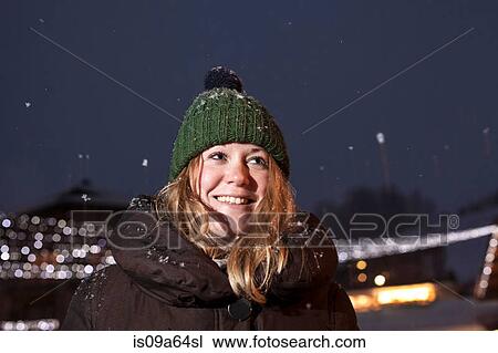 Smiling woman standing in snow View Large Photo Image Stock Image - Smiling woman standing in snow. Fotosearch