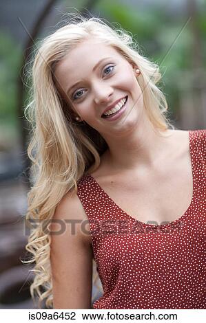 Smiling woman standing outdoors View Large Photo Image Stock Image - Smiling woman standing outdoors. Fotosearch