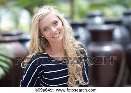 Stock Photograph - Smiling woman standing outdoors. Fotosearch