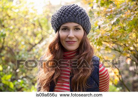 Stock Photograph - Smiling woman standing outdoors. Fotosearch