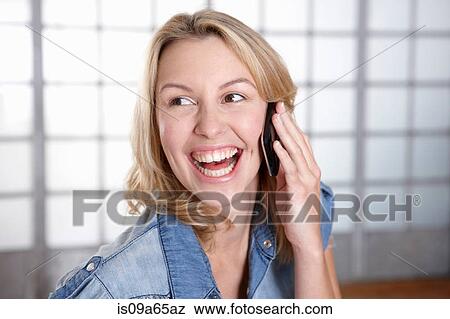 Stock Photo - Smiling woman talking on cell phone. Fotosearch