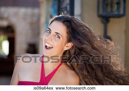 Stock Photo - Smiling woman tossing her hair. Fotosearch