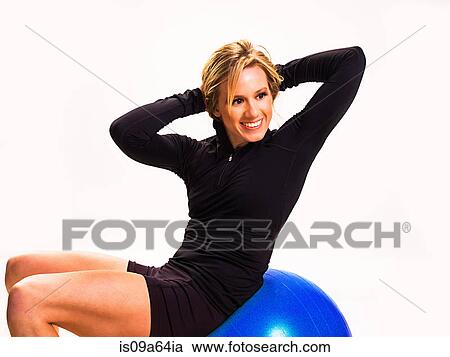 Smiling woman using exercise ball View Large Photo Image Stock Image - Smiling woman using exercise ball. Fotosearch