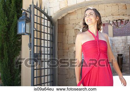 Stock Photograph - Smiling woman walking outdoors. Fotosearch