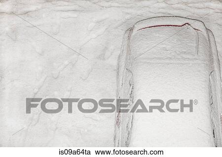 Stock Image - Snow-covered car in driveway. Fotosearch